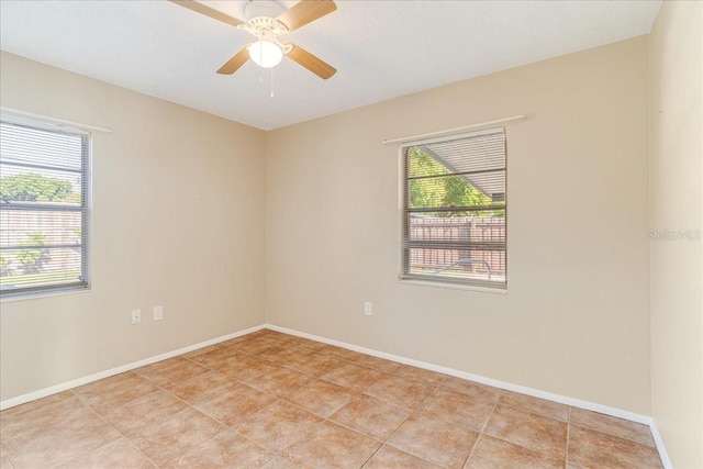 spare room featuring light tile patterned flooring and ceiling fan