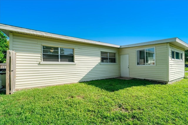 back of house with a lawn