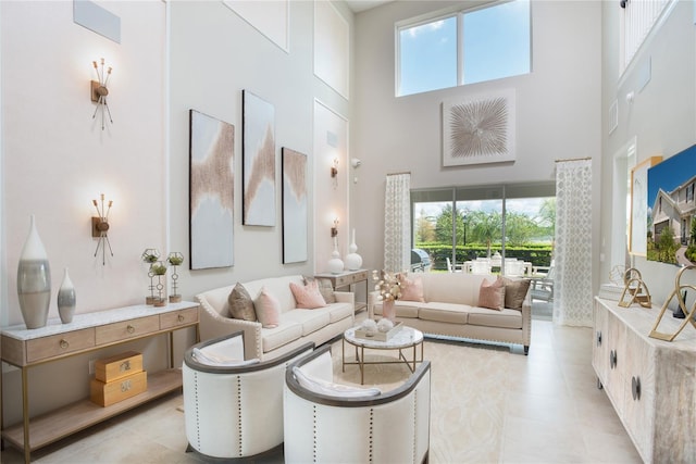 tiled living room featuring a high ceiling and a wealth of natural light