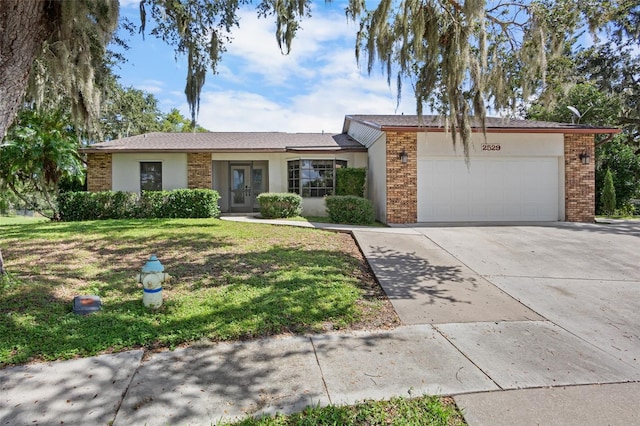 single story home featuring a front yard and a garage