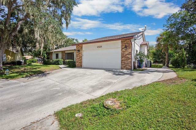 ranch-style home featuring a garage and a front yard