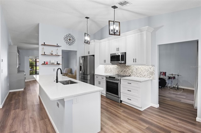 kitchen featuring sink, a center island with sink, white cabinetry, stainless steel appliances, and dark hardwood / wood-style floors