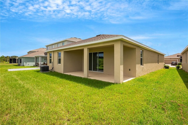 back of house with a yard, central AC, and a patio area