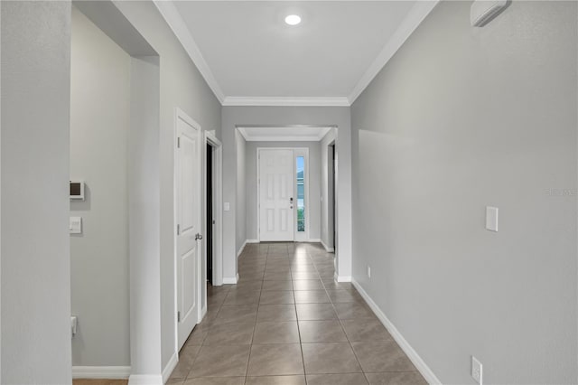 corridor with light tile patterned flooring and ornamental molding