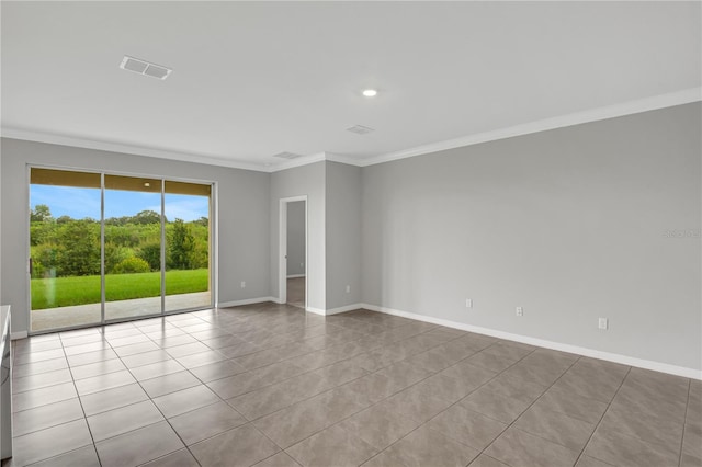 spare room featuring light tile patterned floors and ornamental molding