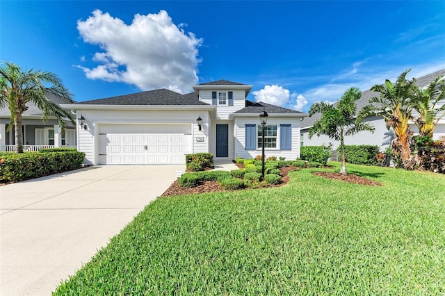 view of front of home with a garage and a front lawn