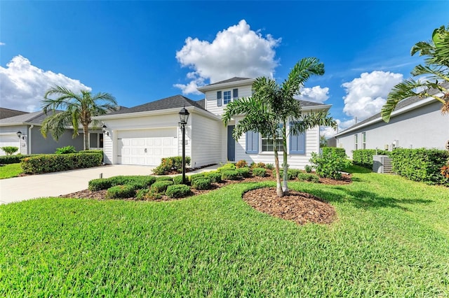 view of front of house with a garage and a front lawn