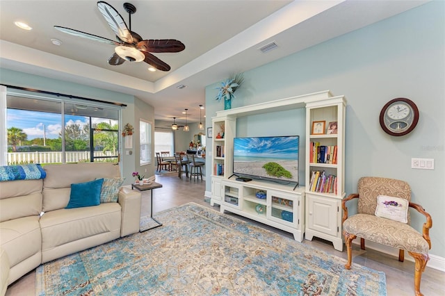 living room with tile patterned floors and ceiling fan