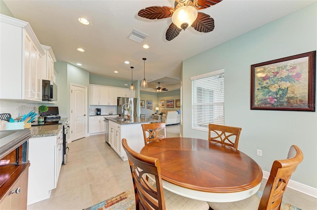 tiled dining room with ceiling fan