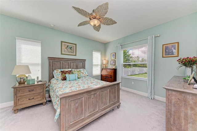 bedroom featuring ceiling fan and light carpet