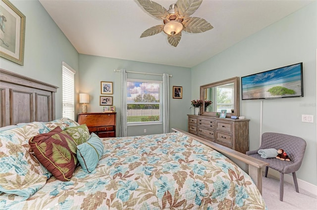 carpeted bedroom with multiple windows and ceiling fan