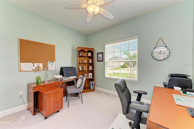 carpeted office featuring ceiling fan