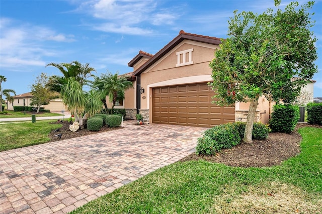 view of front of property featuring a garage and a front lawn