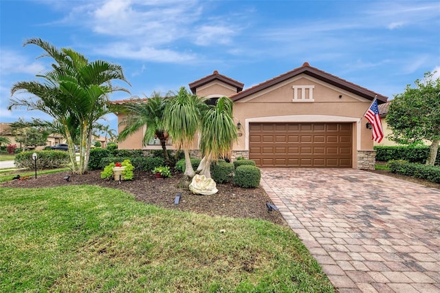 view of front facade with a garage and a front lawn