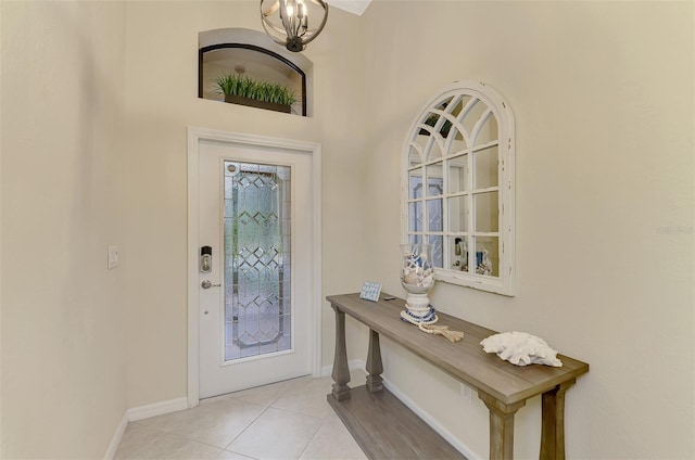 foyer entrance featuring light tile patterned floors and a notable chandelier