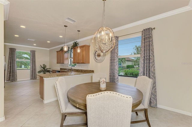 dining area featuring ornamental molding, sink, light tile patterned floors, and a chandelier