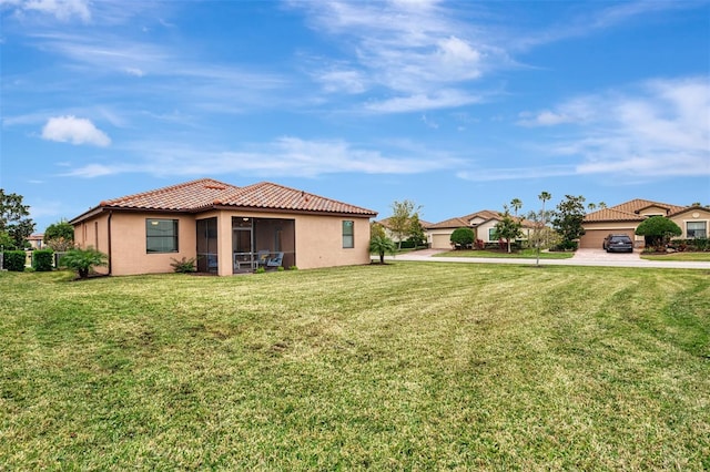 view of yard with a garage and a sunroom