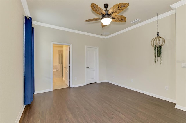 empty room featuring crown molding, dark wood-type flooring, and ceiling fan