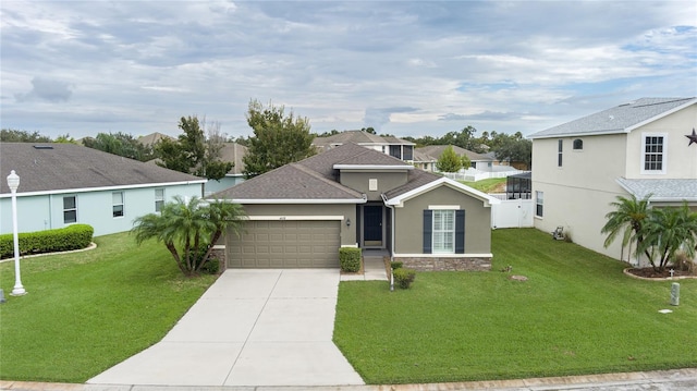 view of front of property featuring a front lawn and a garage