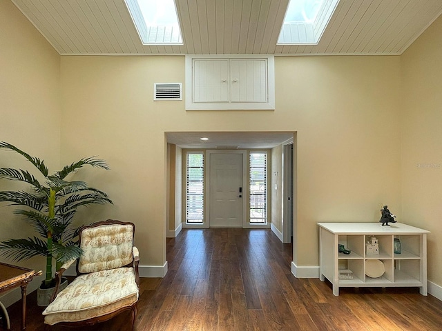 entrance foyer with wood ceiling, a skylight, and dark hardwood / wood-style floors