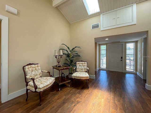 entrance foyer featuring vaulted ceiling with skylight, wood ceiling, and dark hardwood / wood-style floors