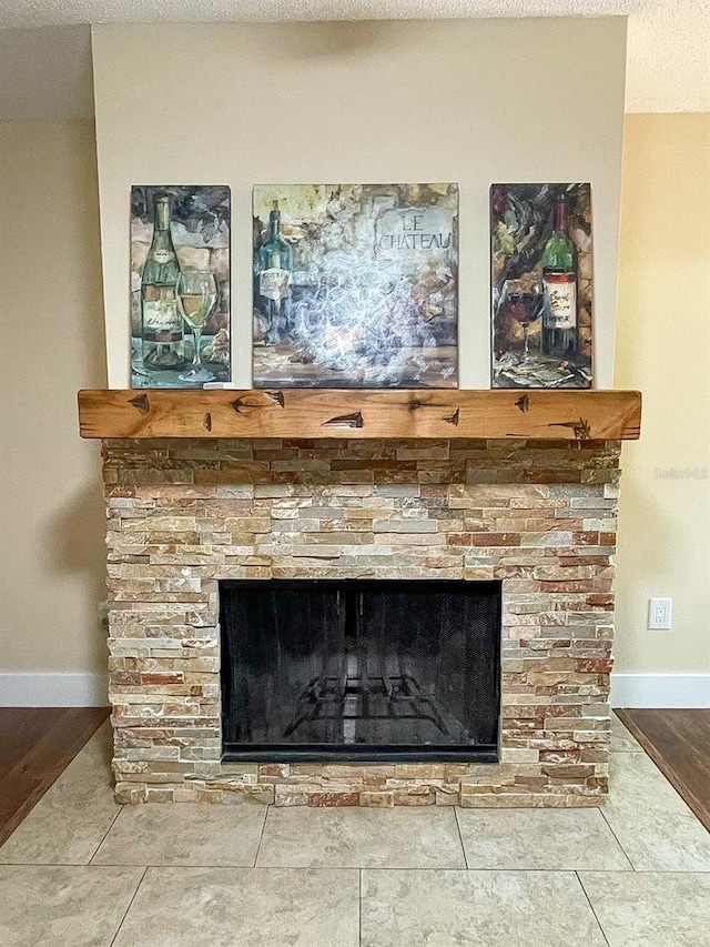 details featuring a textured ceiling, a fireplace, and hardwood / wood-style floors