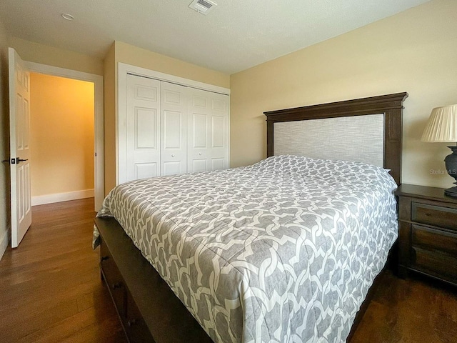 bedroom featuring a closet and dark hardwood / wood-style floors