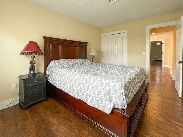 bedroom featuring a closet and dark wood-type flooring