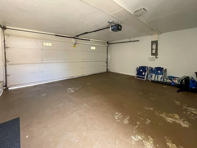 garage with electric panel and a garage door opener