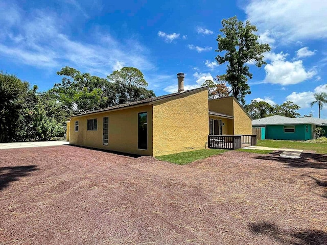 back of property with a wooden deck