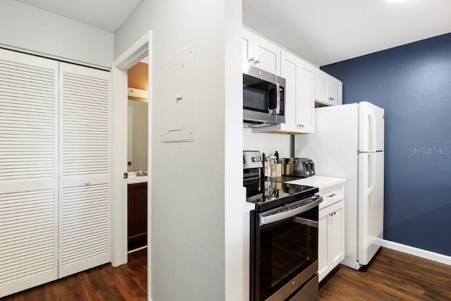 kitchen featuring white cabinets, appliances with stainless steel finishes, and dark wood-type flooring