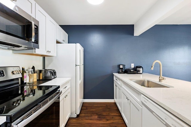 kitchen featuring stainless steel appliances, sink, and white cabinetry