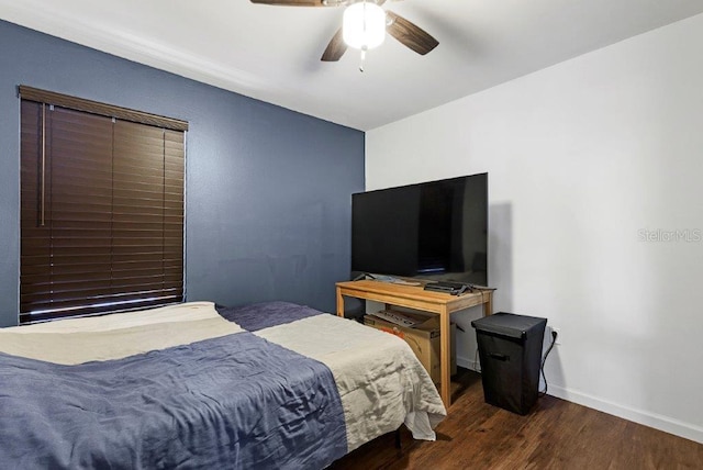 bedroom with ceiling fan and dark hardwood / wood-style floors