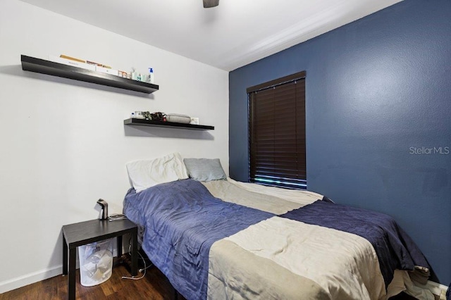 bedroom featuring ceiling fan and dark hardwood / wood-style floors