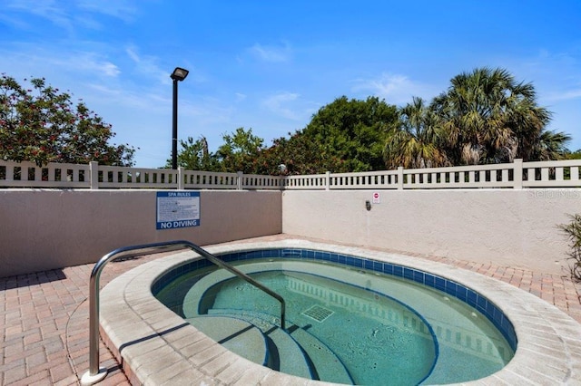 view of swimming pool featuring a community hot tub