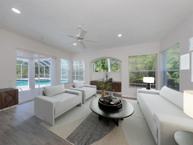 sunroom / solarium with ceiling fan and a pool