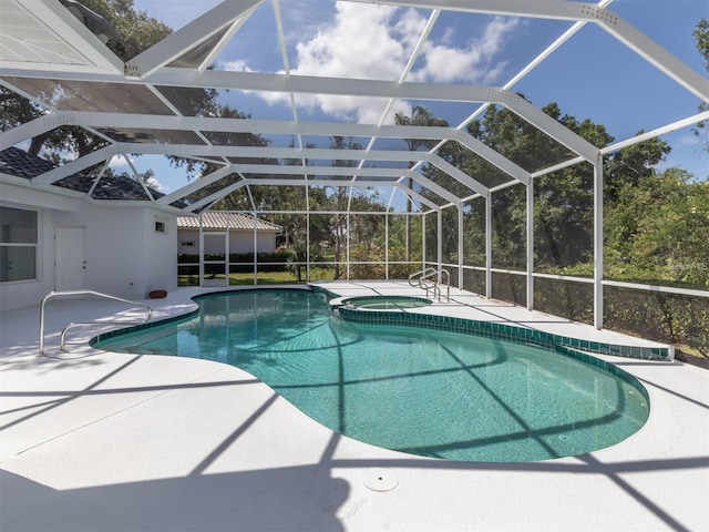 view of pool featuring glass enclosure, an in ground hot tub, and a patio area