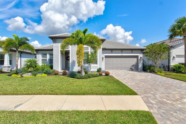 view of front of property with a front yard and a garage