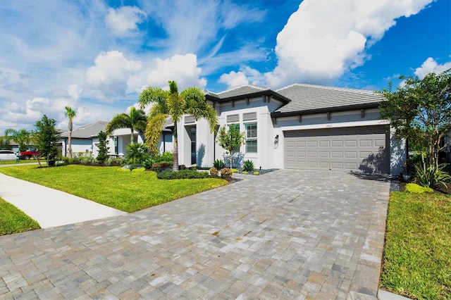 view of front of home with a front yard and a garage