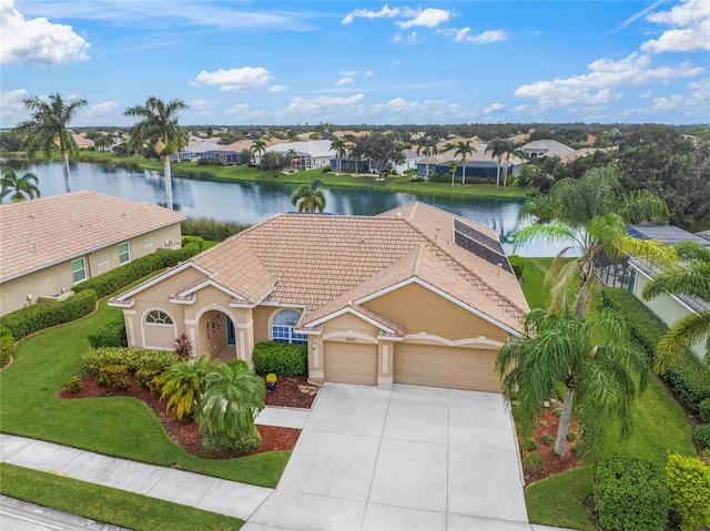 view of front of home with a garage and a water view