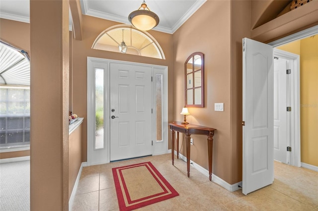 foyer entrance with light tile patterned flooring and crown molding