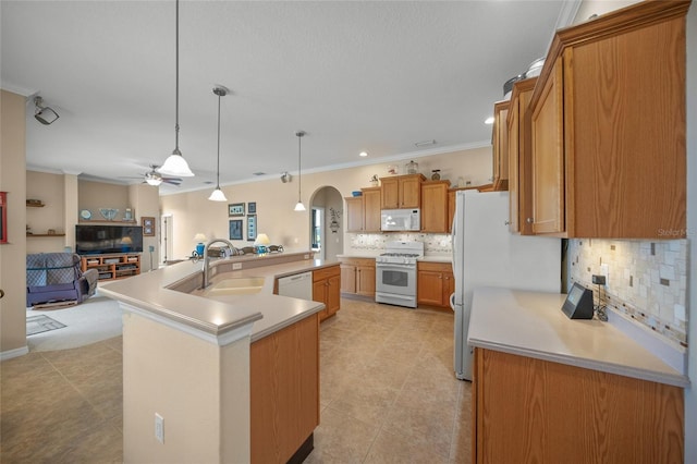 kitchen featuring pendant lighting, sink, white appliances, ceiling fan, and a spacious island