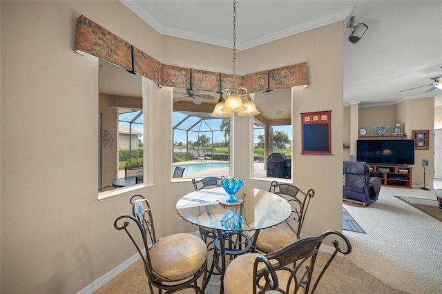 carpeted dining room featuring ceiling fan, plenty of natural light, and crown molding