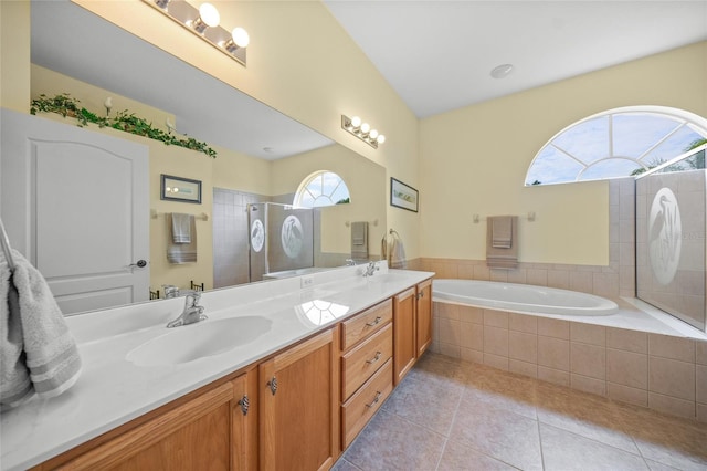 bathroom featuring shower with separate bathtub, vanity, and tile patterned floors