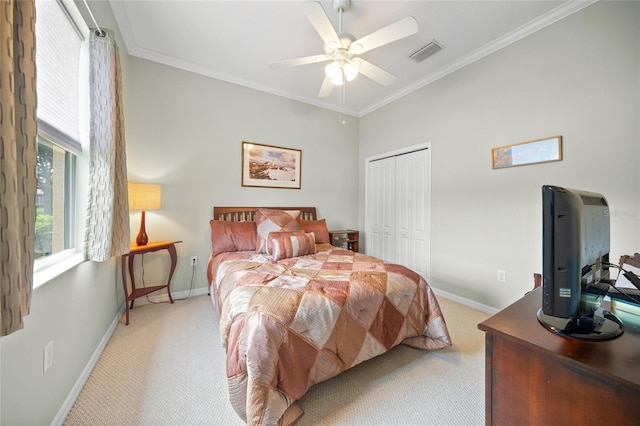 bedroom featuring ceiling fan, light colored carpet, a closet, and crown molding