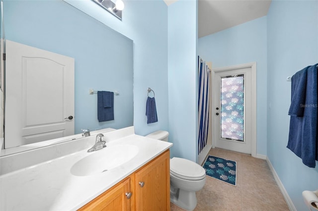 bathroom featuring vanity, toilet, and tile patterned floors