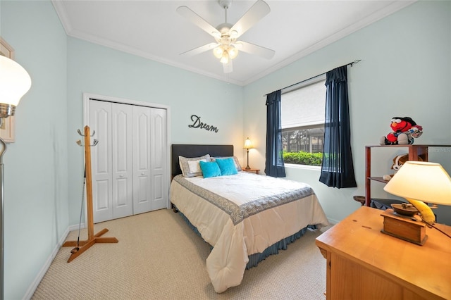 bedroom with a closet, light colored carpet, ceiling fan, and crown molding