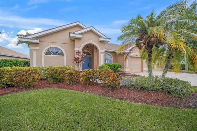 view of front of house with a garage and a front lawn