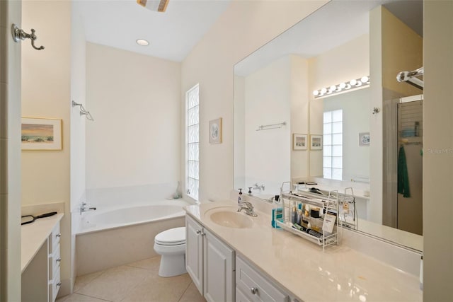 full bathroom with tile patterned floors, vanity, toilet, and a wealth of natural light