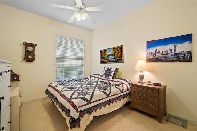 tiled bedroom featuring ceiling fan